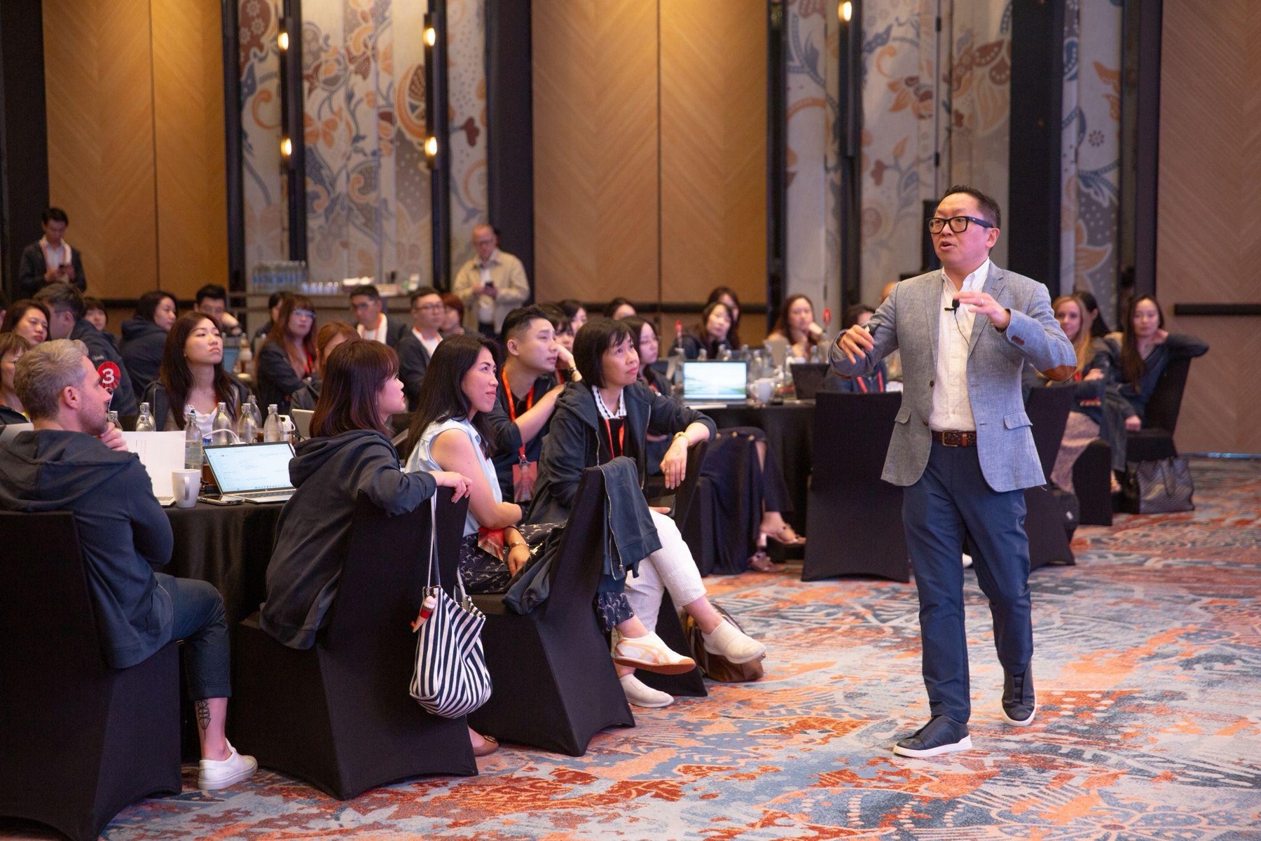 Dux Raymond Sy speaking with attendees at a professional event